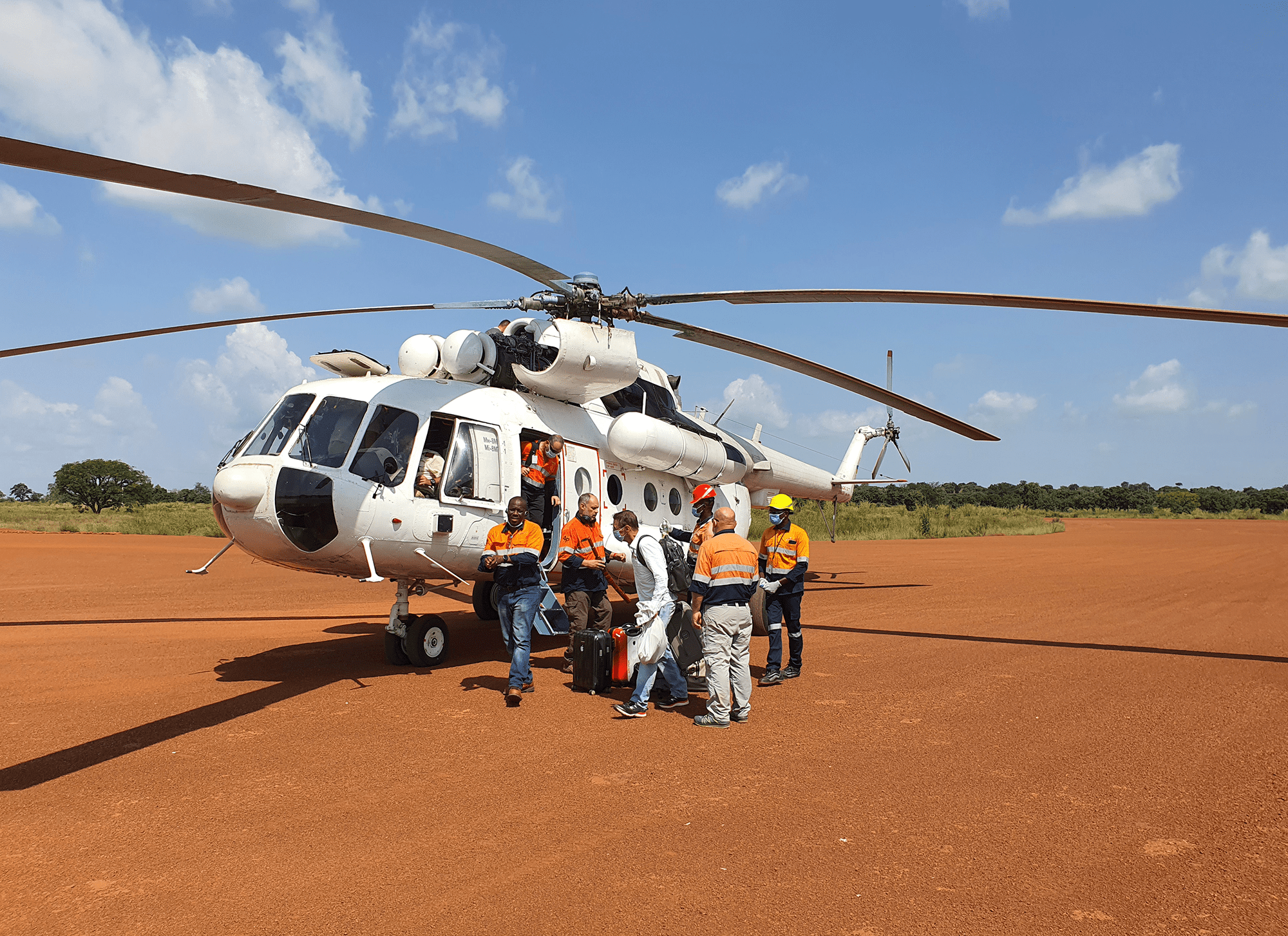 Middle East Freighters. Panafrican Air Services. What we do. Helicopter with people on front.