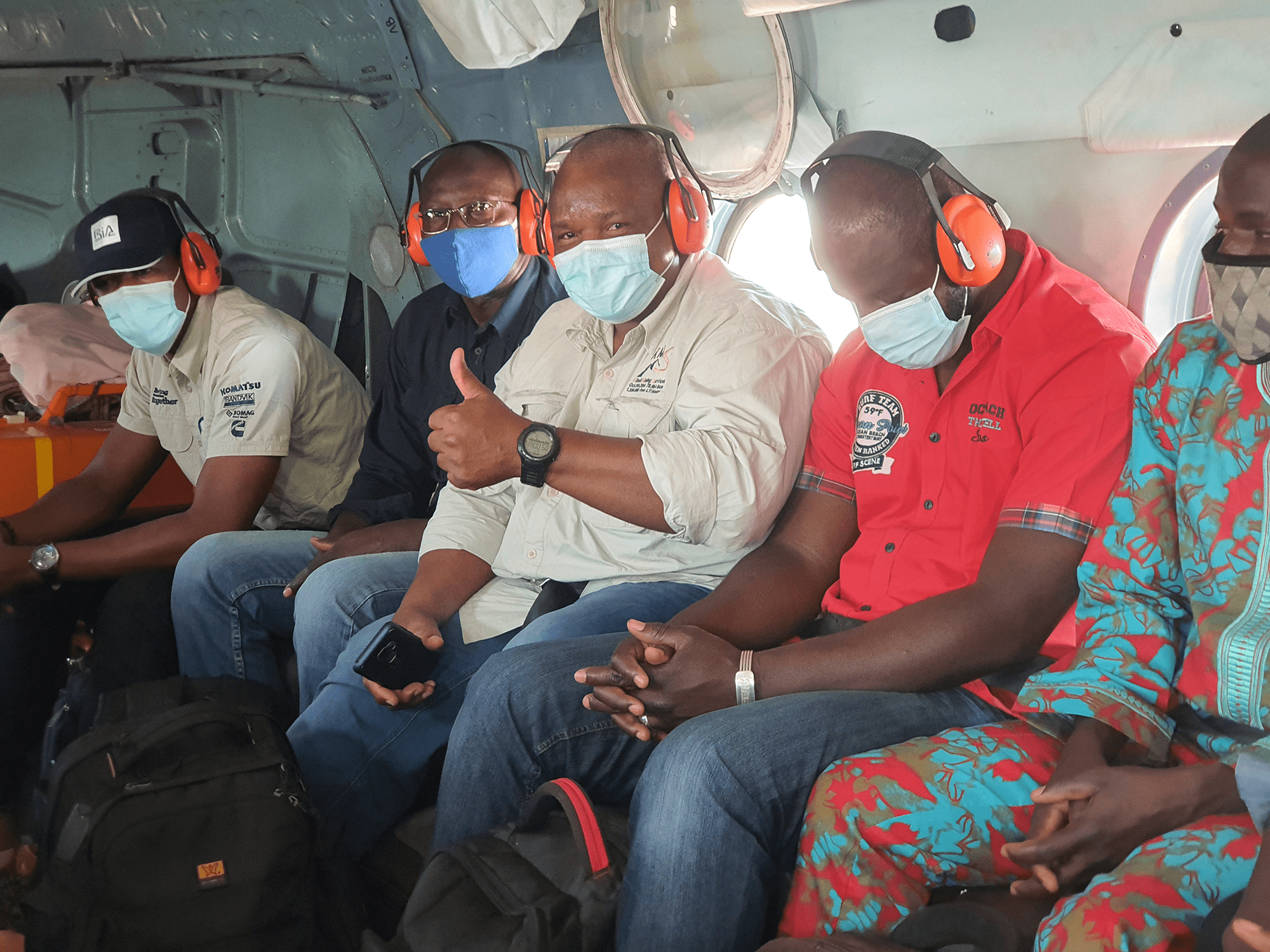 Middle East Freighters. Panafrican Air Services. Passenger. People sitting inside the airplane. Someone give a thumbs up